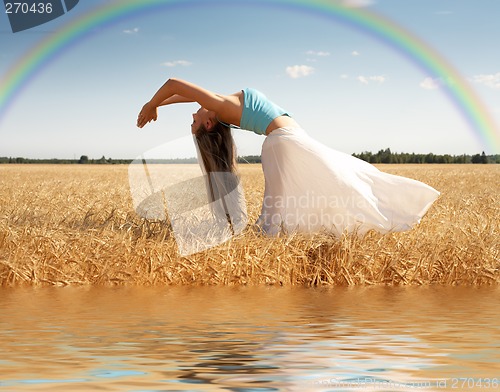 Image of stretching woman with rainbow and water