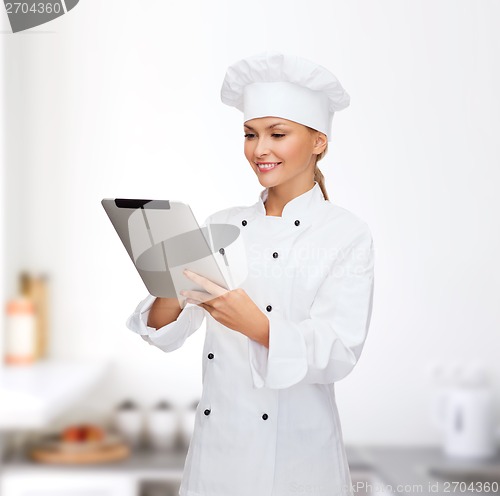 Image of smiling female chef with tablet pc computer