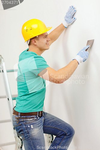 Image of smiling man in helmet doing renovations at home