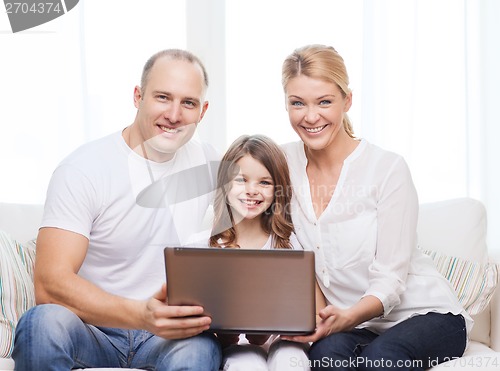 Image of parents and little girl with laptop at home