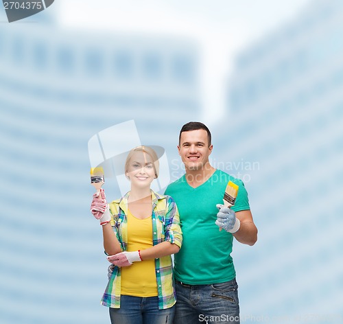 Image of smiling couple with paintbrush