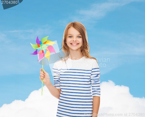 Image of smiling child with colorful windmill toy