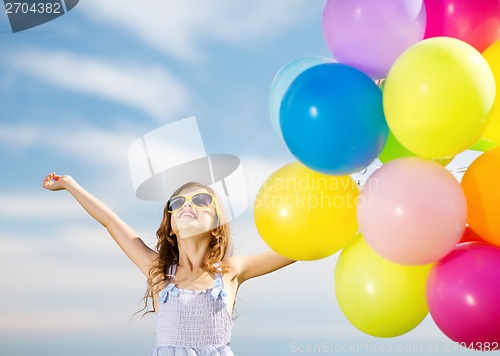 Image of happy girl with colorful balloons