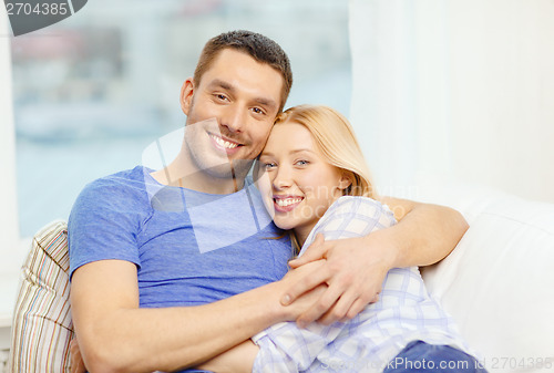 Image of smiling happy couple at home