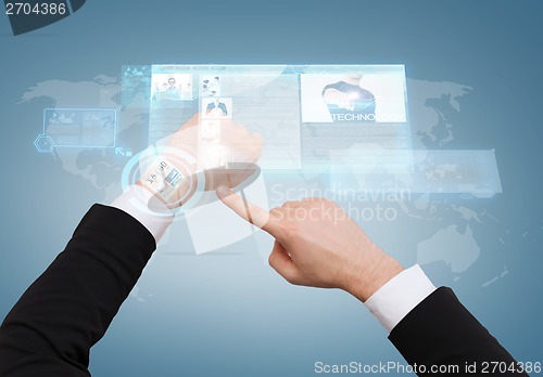 Image of businessman pointing to virtual watch at his hand