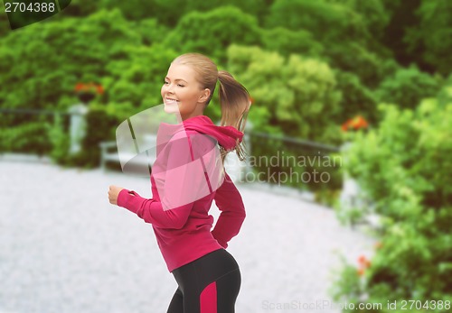 Image of sporty woman running or jumping