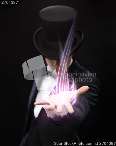 Image of magician holding something on palm of his hand