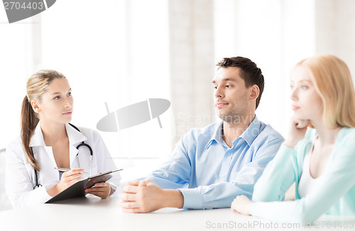 Image of doctor with patients in cabinet