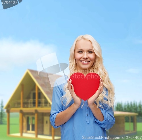 Image of smiling woman with red heart