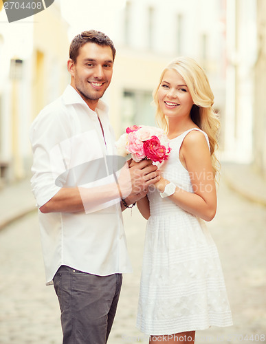 Image of couple with flowers in the city