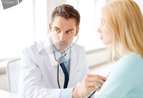 Image of doctor with stethoscope listening to the patient