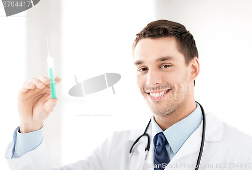 Image of male doctor holding syringe with injection