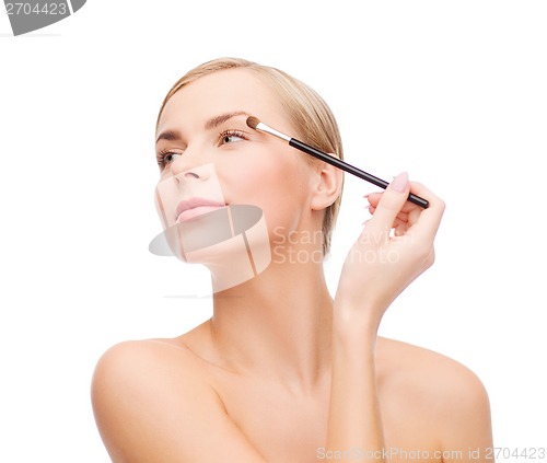 Image of beautiful woman with makeup brush