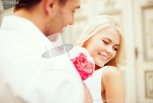 Image of couple with flowers in the city