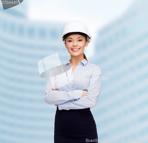 Image of friendly smiling businesswoman in white helmet