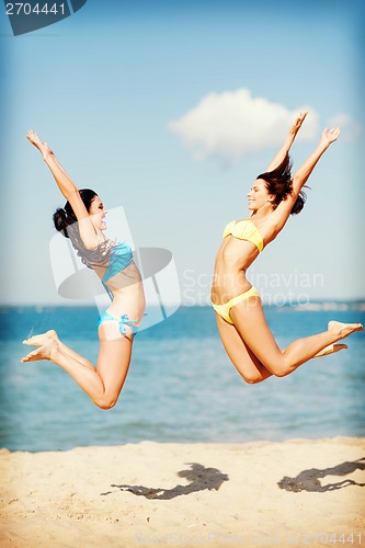 Image of girls jumping on the beach