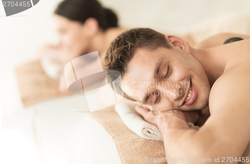 Image of couple in spa with hot stones