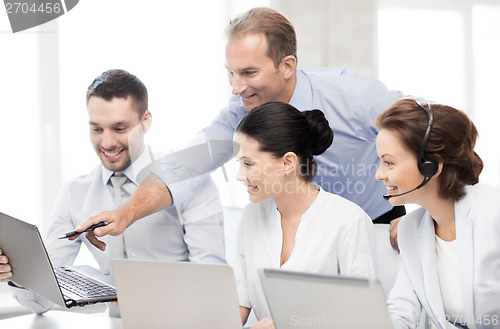 Image of group of people working in call center