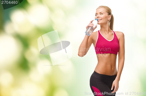 Image of smiling woman with bottle of water