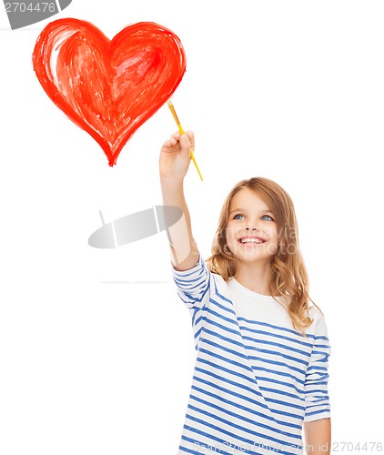 Image of cute little girl drawing heart with brush