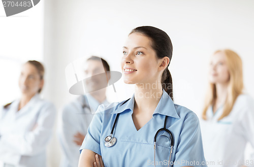 Image of female doctor in front of medical group