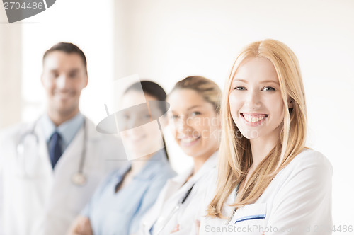 Image of female doctor in front of medical group