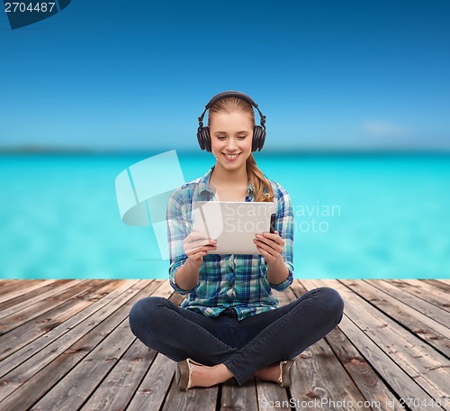 Image of young woman in casual clothes sitting on floor