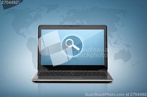 Image of laptop computer with magnifying glass on screen