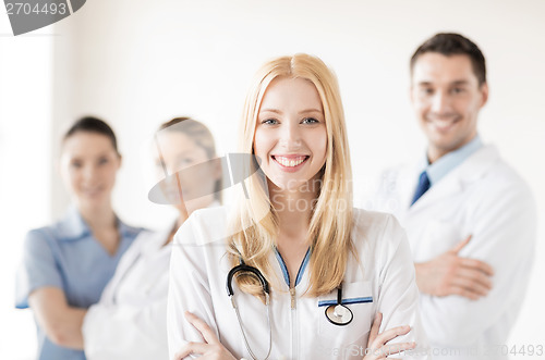 Image of female doctor in front of medical group