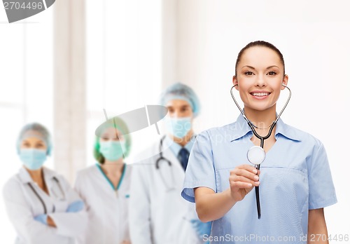 Image of smiling female doctor or nurse with stethoscope