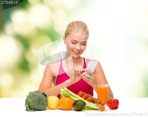 Image of woman with vegetables pointing at smartphone