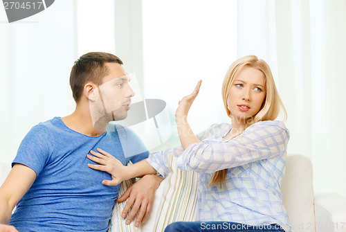 Image of unhappy couple having argument at home