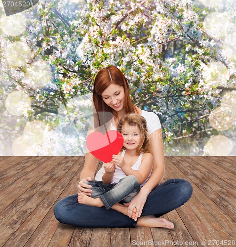 Image of happy mother with adorable little girl and heart