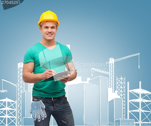 Image of smiling man in helmet with clipboard