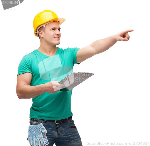 Image of smiling man in helmet with clipboard