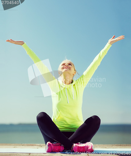 Image of woman doing yoga outdoors