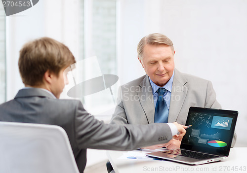 Image of older man and young man with laptop computer