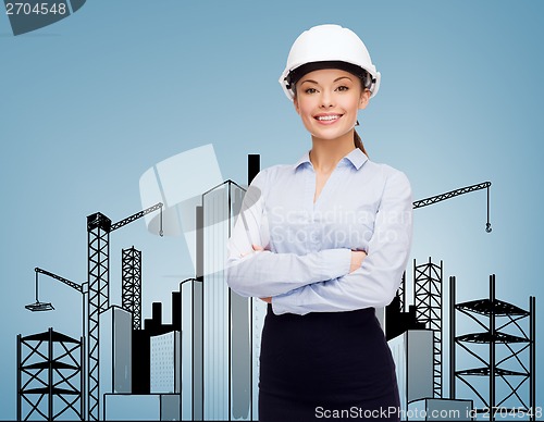 Image of friendly smiling businesswoman in white helmet