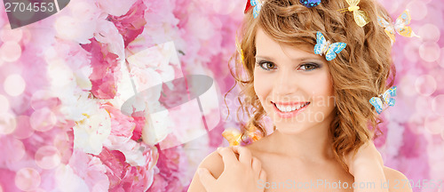 Image of happy teenage girl with butterflies in hair