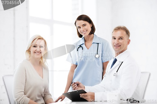 Image of doctor and nurse with patient in hospital