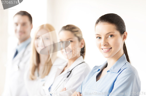 Image of female doctor in front of medical group