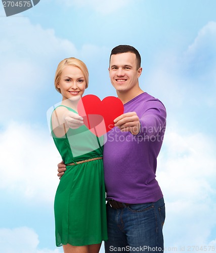 Image of smiling couple holding big red heart