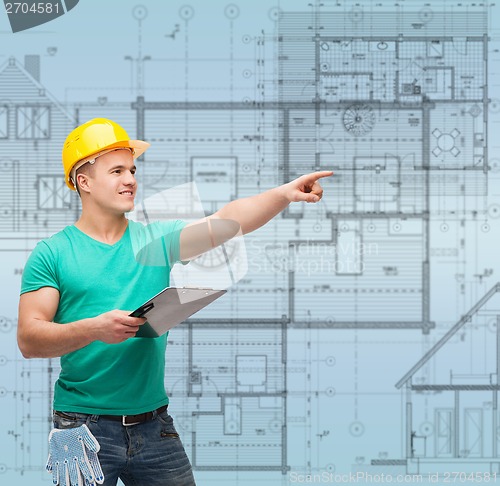 Image of smiling man in helmet with clipboard