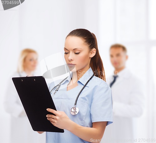 Image of serious female doctor or nurse with stethoscope