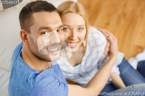 Image of smiling happy couple at home