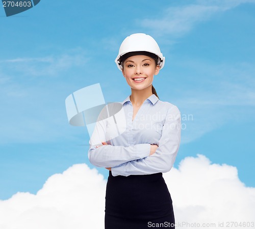 Image of friendly smiling businesswoman in white helmet