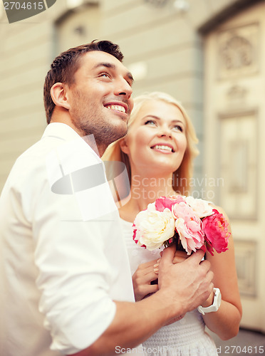 Image of couple with flowers in the city