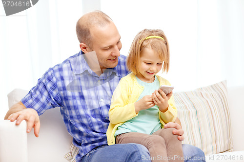 Image of happy father and daughter with smartphone