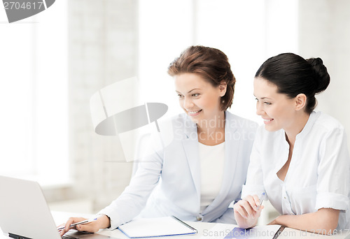 Image of businesswomen working with laptop in office