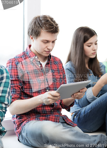 Image of student looking into tablet pc at school